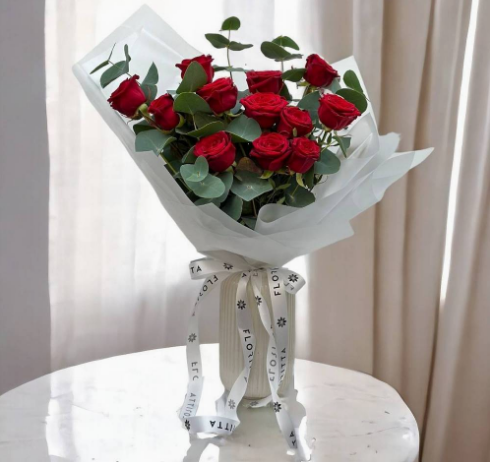 12 red roses with eucalyptus